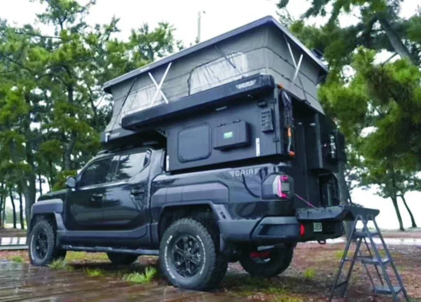 TUYU T2 flat-front pop-top camper fitted to a black pickup with the roof canvas raised