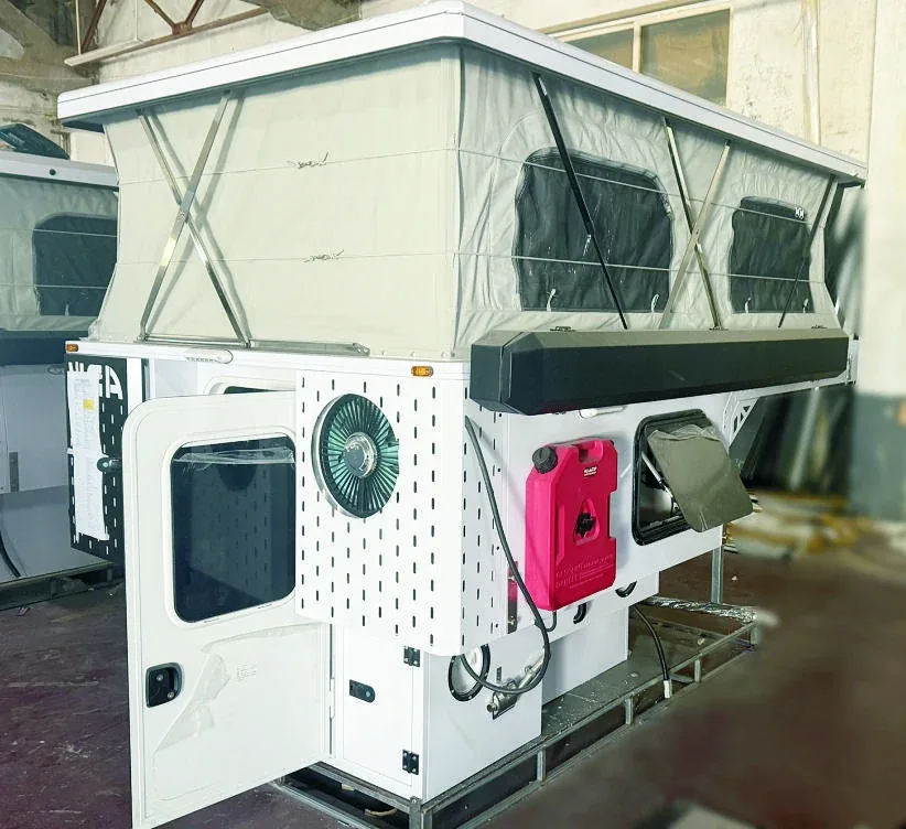 TUYU T6 hard-fold camper body in the workshop showing the folding roof structure